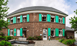 Das Ulla-Hahn-Haus von außen. Kinder gucken aus dem Fenster.